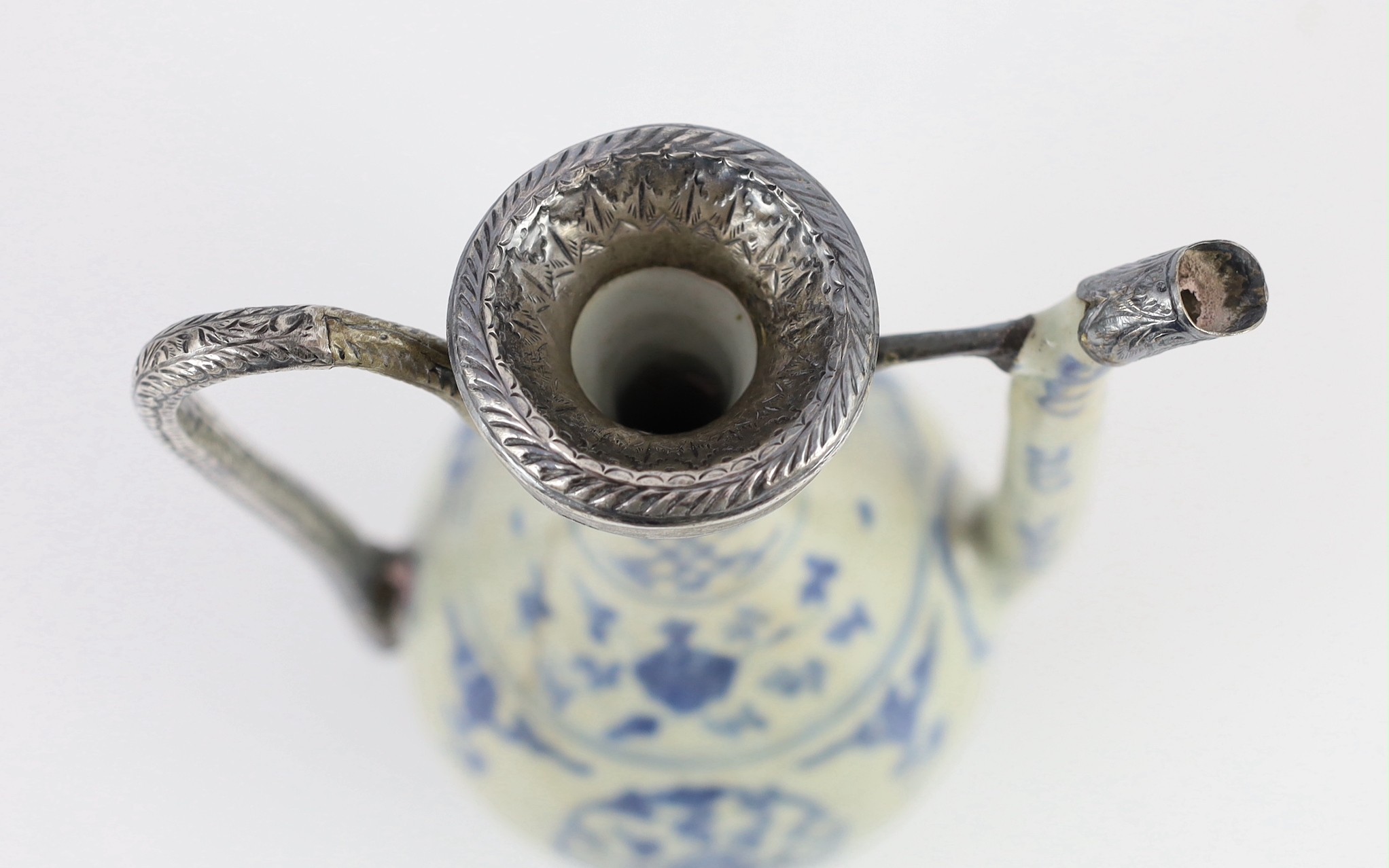 A Chinese late Ming blue and white ewer, made for the Islamic market, Jiajing to Wanli period, 21cm high, damage and later Islamic silver mounts